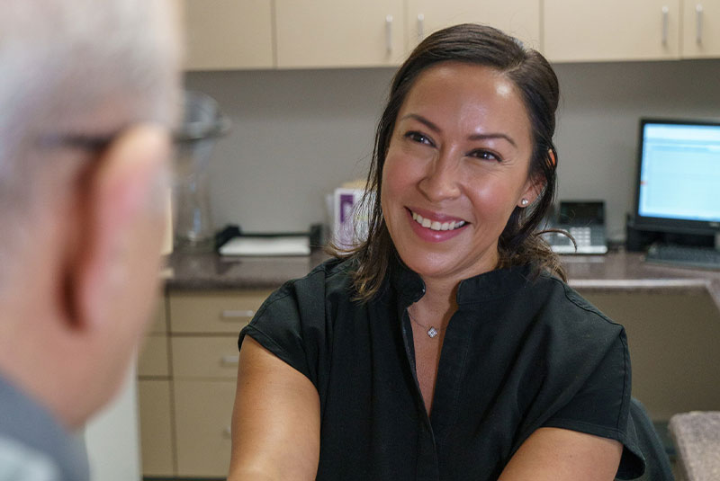 staff member smiling with patient